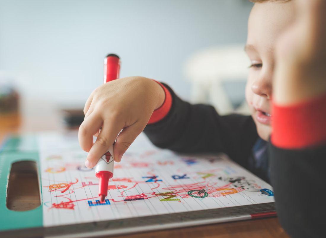Child scribbling with marker pen