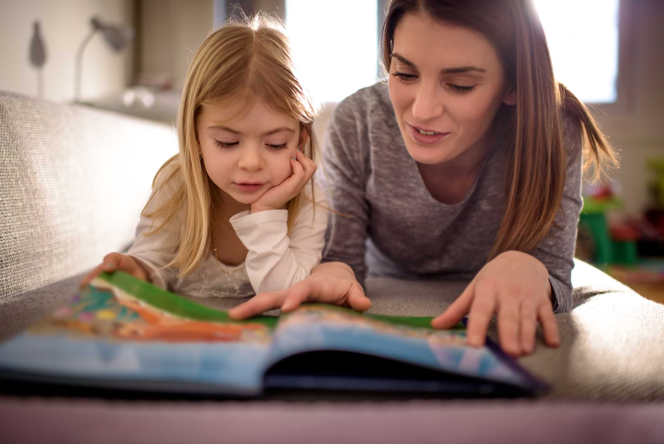 mother and daughter learning reading book